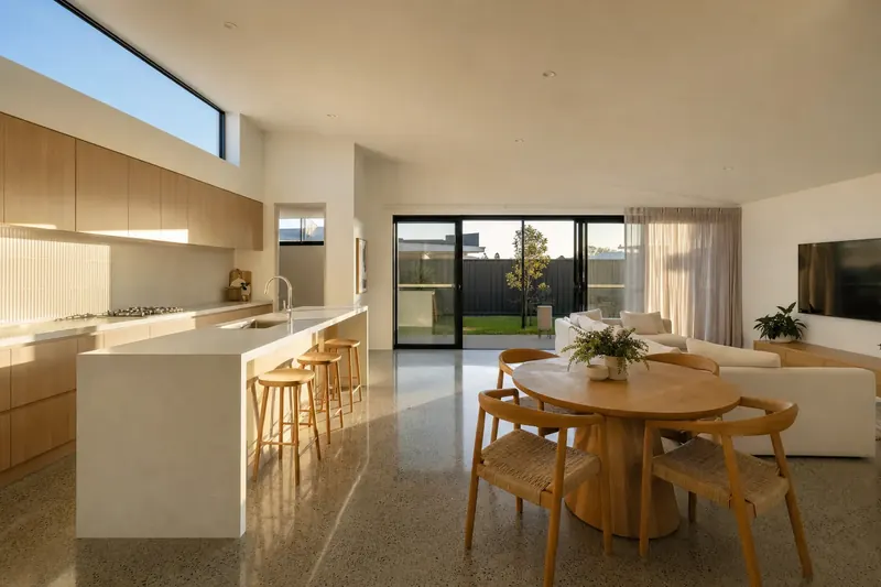 31 Quandong Place inside: kitchen, dining and living under a raked ceiling with a clerestory window
