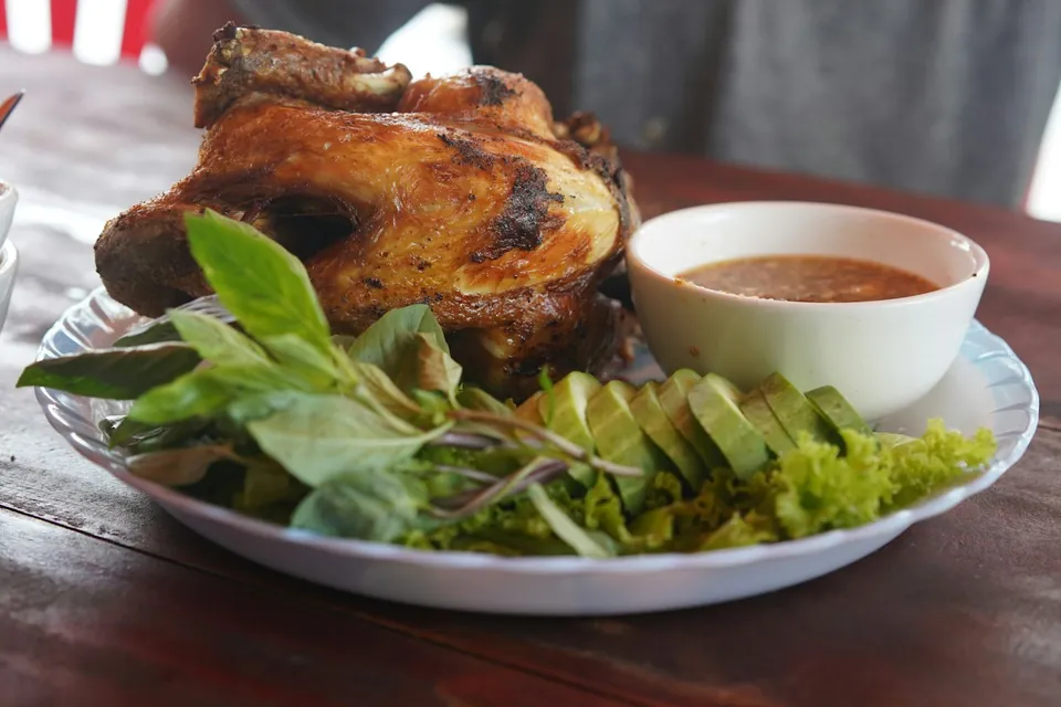 Grilled chicken with Thai basil, cucumber and a bowl of jaew dipping sauce