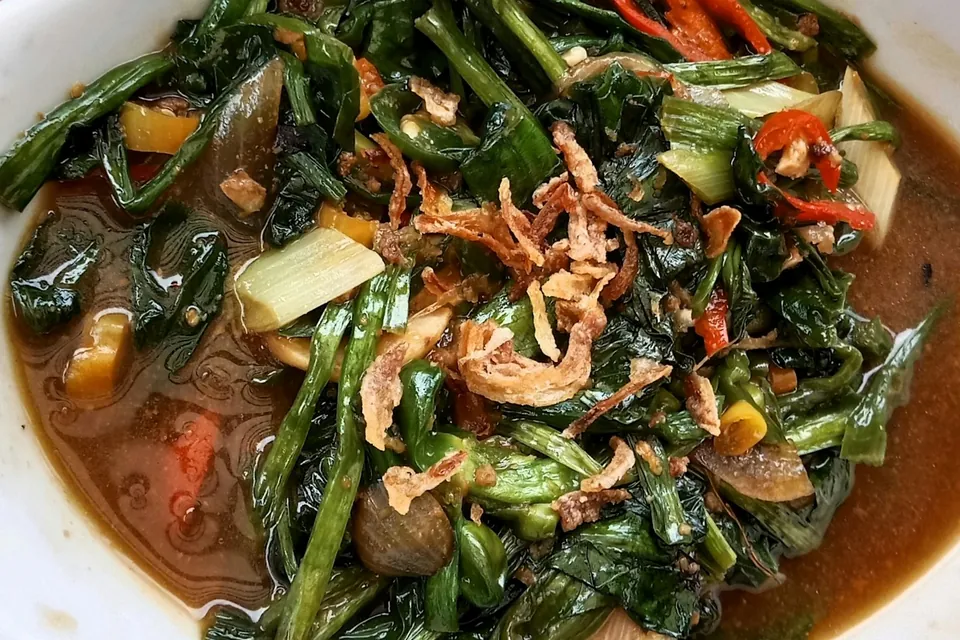 Wok-fried greens with chilli and fried shallot in a savoury sauce