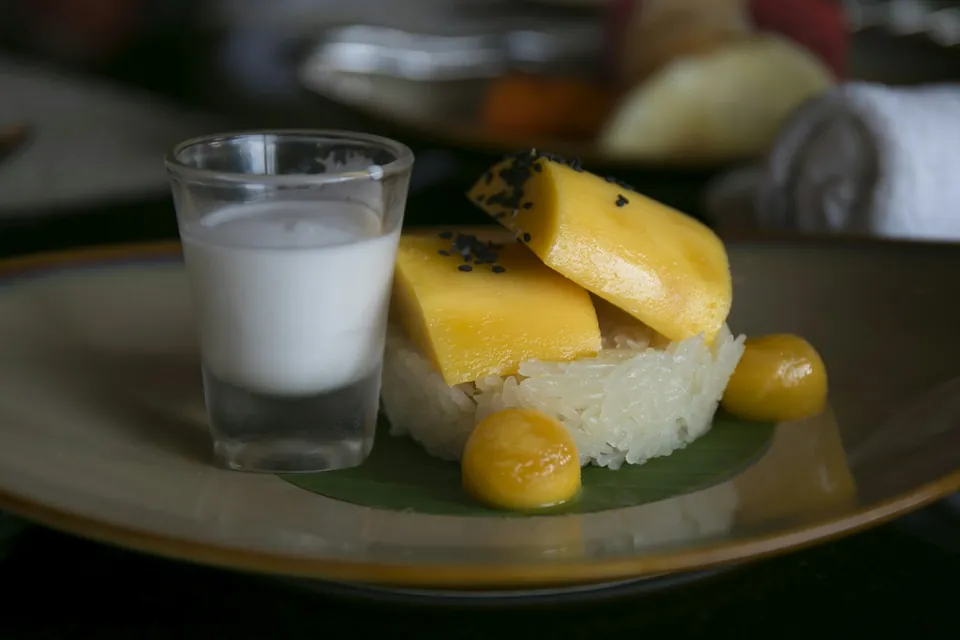 Mango slices on sticky rice with a shot of coconut cream